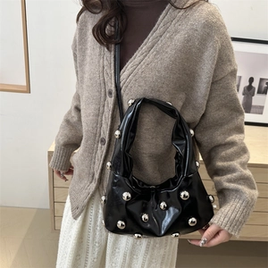 Sac sous le bras noir brillant avec boules métalliques argentées et bandoulière