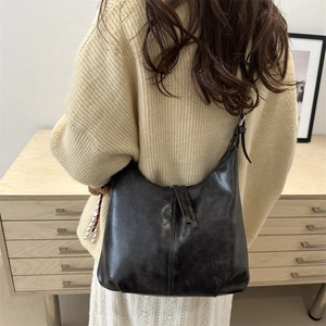 Retro black leather hobo tote bag for women showing a minimalist shoulder carry style