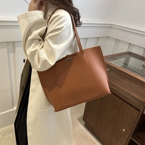 Minimalist brown tote bag in premium faux leather for stylish commuting and daily use