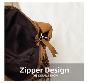 Detail shot of the zipper design and brown suede fringe on the retro dumpling crossbody bag