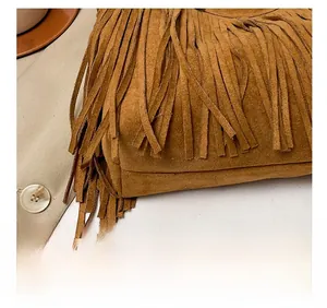 Detail of precise stitching on the caramel brown suede tassel tote bag for women