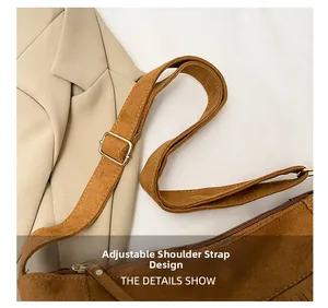 Detail of adjustable shoulder strap with gold buckle on brown suede fringe bag