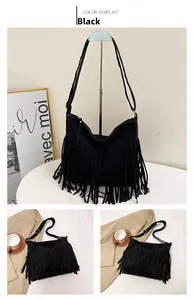 Detail of black suede-textured shoulder bag featuring long bohemian style fringe tassels