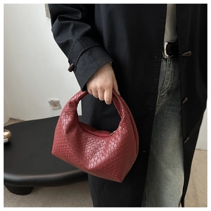 Detail of red woven leather hobo bag showing the luxury Intrecciato craftsmanship