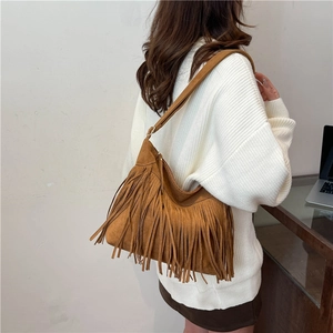 Brown suede shoulder bag with tassel fringe in a bohemian vintage style for women