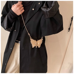 Close-up of a mini golden butterfly chain bag with intricate rhinestone embellishments