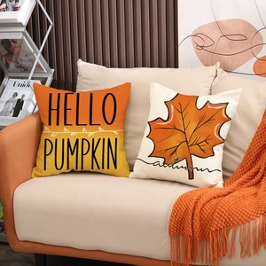 Autumn throw pillows featuring orange maple leaf and Hello Pumpkin print on linen covers