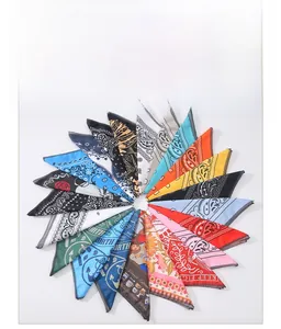 Detailed view of assorted paisley and floral print bandanas with neat edge stitching