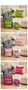 Detail of Halloween pillow covers with pumpkin patterns on a soft fabric sofa
