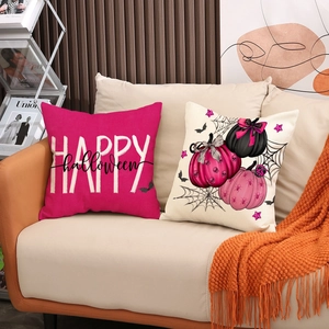 Halloween throw pillow set featuring Happy Halloween lettering and pumpkin patterns on sofa