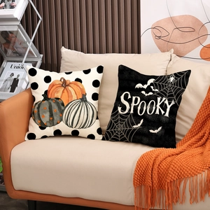 Two-piece Halloween pillow covers with pumpkin patterns and Spooky text on a sofa