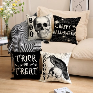Set of 4 Halloween skull and raven linen pillow covers on a cozy sofa with decor