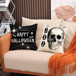 Halloween decorative pillow covers with skull and Happy Halloween text on a sofa