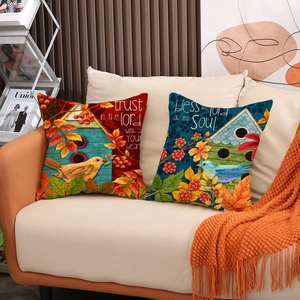Lot de deux housses de coussin en lin avec motifs d'oiseaux et citations sur canapé
