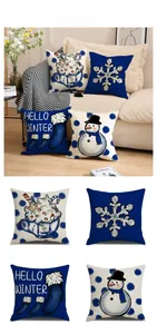 Detail of winter pillow covers featuring navy blue snowman and snowflake patterns