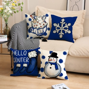 Set of four Christmas snowman throw pillow covers on a sofa with winter patterns