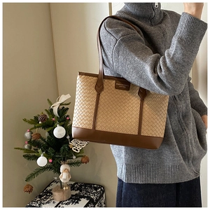 Detail of woven tote bag texture with leather straps and festive background decor