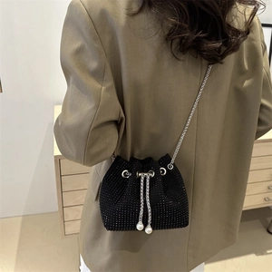 Sparkling black rhinestone bucket bag with silver chain and pearl drawstring charms