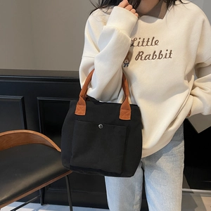 Sac fourre-tout minimaliste en toile noire avec poignées orange et poche à bouton pression