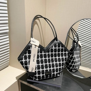 Fashionable black and white plaid tweed tote bag with leather straps and logo ribbon