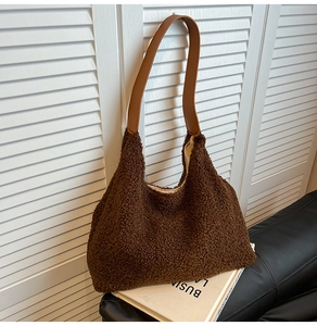 Detailed close-up of dark brown plush teddy fabric tote bag with premium leather straps