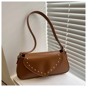 Detailed close-up of brown PU leather shoulder bag with gold rivet accents on the V-shaped flap