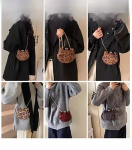 Detailed views of leopard print cat-shaped mini crossbody bags with gold chain straps