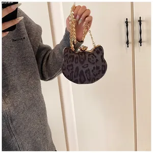Close-up of leopard print cat-shaped mini bag with gold chain and gem-encrusted clasp