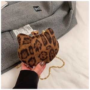 Detailed close-up of leopard print cat-shaped evening bag with gold chain and diamond clasp