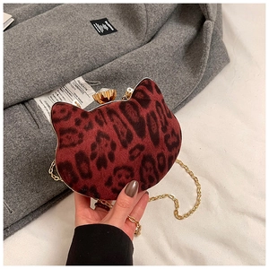 Close-up of cat-shaped mini bag with red leopard print and crystal buckle