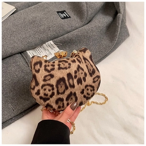 Close-up of leopard print cat-shaped mini bag with gold chain and plush fur texture