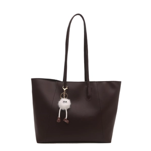 Minimalist deep brown leather tote bag with white plush charm for commute and daily use