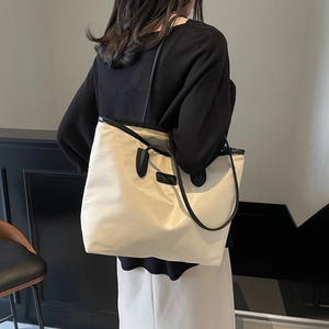 Minimalist large capacity nylon tote bag in cream white with black shoulder straps