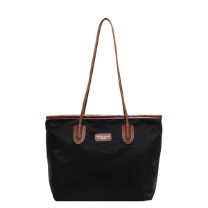 Minimalist large black nylon tote bag with brown leather handles for commuting