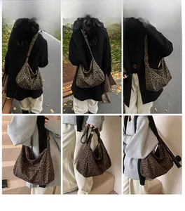 Outdoor lifestyle view showing large leopard print crossbody bag with adjustable strap