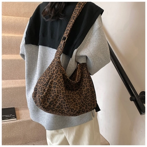 Detailed back view of a large leopard print hobo bag showing its size and wide strap