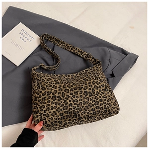 Detail of leopard print tote bag featuring a durable canvas texture and adjustable strap