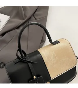 Detail of contrast stitching with black leather, beige weave and round handle