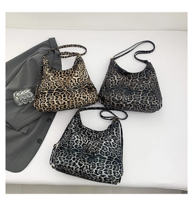 Flat lay of large capacity leopard print tote bags in three colors with adjustable straps