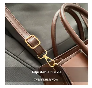 Detail of adjustable golden buckle and premium brown leather strap on women's handbag