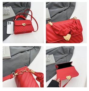 Detail view of red PU leather bag with gold heart lock and pleated cloud handle