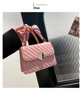 Pink pleated handbag with V-shaped quilting and golden heart twist lock detail
