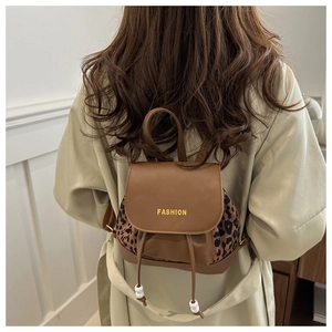 Detail of mini backpack with leopard print panels and decorative drawstring beads