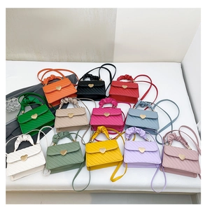 Collection of pleated crossbody bags in 12 vibrant colors with gold heart buckles