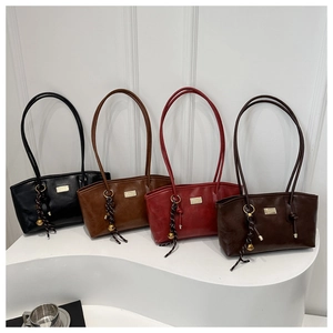Detail view of four large capacity tote bags in black, brown, red, and coffee with tassels