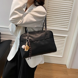Classic black PU leather Boston bag for women with a unique baseball theme pendant detail