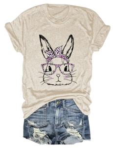 Detail of oatmeal t-shirt featuring a cartoon bunny with pink leopard headband and denim shorts
