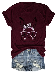 Flat lay of a burgundy rabbit print t-shirt paired with frayed denim shorts
