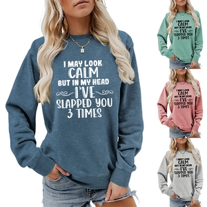 Detail view of women's crewneck sweatshirts in blue, green, pink, and grey colors
