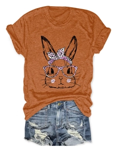 Detail of pink leopard rabbit print on orange t-shirt paired with denim shorts